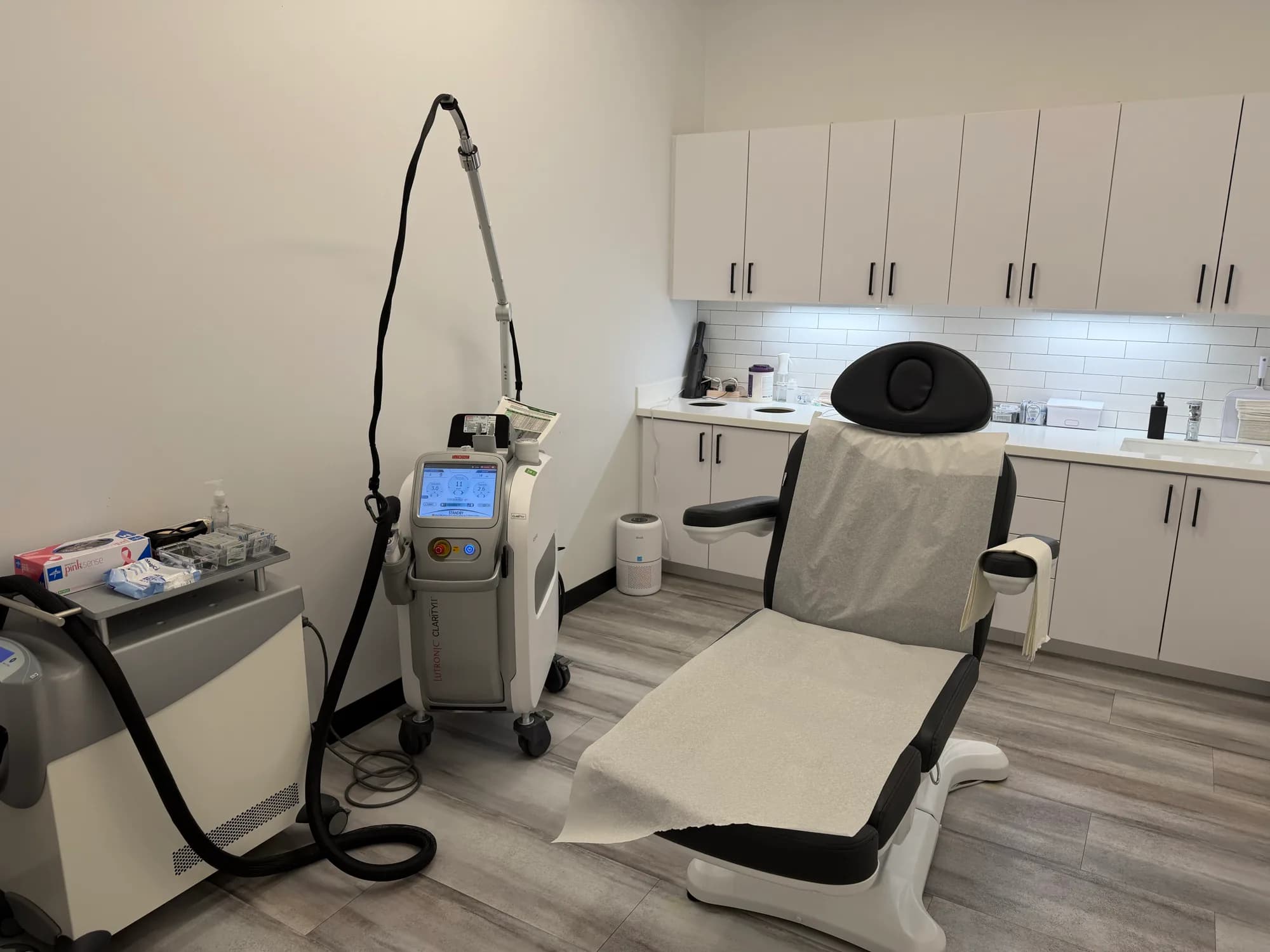 Laser treatment room with a treatment chair and laser equipment at Beauty Lab + Laser in Riverton, Utah.