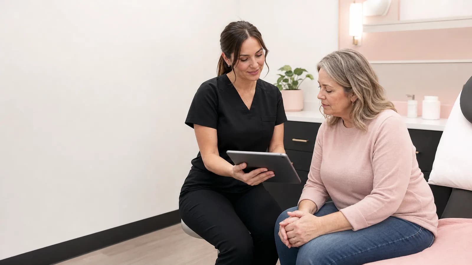 Medical provider reviewing a personalized weight-management plan with an adult client.